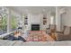 Bright, airy living room with built-in shelving, a fireplace, and a large picture window at 109 Chimeneas Pl, Chapel Hill, NC 27517