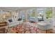 Spacious living room with hardwood floors, large windows, and views of the outdoor pool at 109 Chimeneas Pl, Chapel Hill, NC 27517