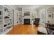 Cozy living room with built-in bookshelves, a fireplace, and a comfortable chair, perfect for relaxing at 109 Chimeneas Pl, Chapel Hill, NC 27517