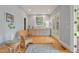 Living room featuring hardwood floors, light-colored walls, and a small bar area with a window at 109 Chimeneas Pl, Chapel Hill, NC 27517