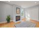Living room featuring hardwood floors, light-colored walls, a fireplace, and a closet at 109 Chimeneas Pl, Chapel Hill, NC 27517