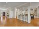 Open concept living space with hardwood floors connecting the kitchen and living areas at 109 Chimeneas Pl, Chapel Hill, NC 27517