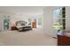 Expansive main bedroom with large windows and neutral carpet at 109 Chimeneas Pl, Chapel Hill, NC 27517