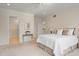 Spacious main bedroom with carpet, neutral walls, and ensuite bathroom provides a luxurious retreat at 109 Chimeneas Pl, Chapel Hill, NC 27517