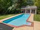 View of the pool house with a swimming pool at 109 Chimeneas Pl, Chapel Hill, NC 27517