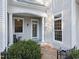 Covered front porch with rocking chair and mature landscaping at 109 Chimeneas Pl, Chapel Hill, NC 27517