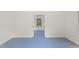 A bright room with blue flooring, white walls, and an open doorway leading to another room at 109 Chimeneas Pl, Chapel Hill, NC 27517