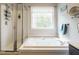 Bright bathroom features a soaking tub, glass-enclosed shower, and natural light at 110 Forest Run Pl, Cary, NC 27518