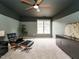 Modern bedroom featuring a ceiling fan, neutral-colored walls, and a statement chair at 110 Forest Run Pl, Cary, NC 27518
