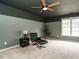 Modern bedroom featuring a ceiling fan, neutral-colored walls, and a statement chair at 110 Forest Run Pl, Cary, NC 27518