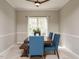 The dining room features a wooden table with blue upholstered chairs and bench seating, complemented by a ceiling fan at 110 Forest Run Pl, Cary, NC 27518