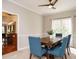 Inviting dining room features a ceiling fan, natural light and blue upholstered chairs at 110 Forest Run Pl, Cary, NC 27518