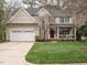 Charming two-story home with a well-manicured lawn and a welcoming front porch at 110 Forest Run Pl, Cary, NC 27518