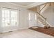 Bright foyer boasts hardwood floors, staircase, and a large window for natural light at 110 Forest Run Pl, Cary, NC 27518