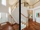 Grand foyer with hardwood floors, staircase with white railings, and abundant natural light creating a welcoming entrance at 110 Forest Run Pl, Cary, NC 27518
