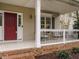 Charming front porch with a brick base and a view of the house's entrance at 110 Forest Run Pl, Cary, NC 27518