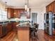 This spacious kitchen features wood cabinets, stainless steel appliances, granite countertops, and a kitchen island with barstool seating at 110 Forest Run Pl, Cary, NC 27518