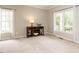 The living room features a console table beneath two windows with white trim and curtains, providing plenty of natural light at 110 Forest Run Pl, Cary, NC 27518