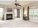 Bright living room features a fireplace, neutral carpet, and large windows offering backyard views at 110 Forest Run Pl, Cary, NC 27518