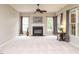 Inviting living room with a cozy fireplace, neutral carpet, and large windows for natural light at 110 Forest Run Pl, Cary, NC 27518