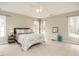 Spacious bedroom featuring natural light, ceiling fan, and neutral-toned furnishings at 110 Forest Run Pl, Cary, NC 27518
