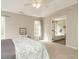 Light-filled main bedroom with a ceiling fan and ensuite bath entrance at 110 Forest Run Pl, Cary, NC 27518