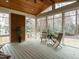 Bright sunroom featuring a wood-paneled ceiling and walls of windows offering backyard views at 110 Forest Run Pl, Cary, NC 27518