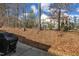 Home's backyard has a wooded area and black chain link fence offering privacy and a secure space at 110 Gulley Glen Dr, Garner, NC 27529