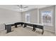 Bright bedroom featuring neutral walls, large windows, and a spacious L-shaped desk setup at 110 Gulley Glen Dr, Garner, NC 27529
