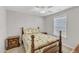 Cozy bedroom with a ceiling fan, neutral walls, plush carpeting, and matching wood furniture at 110 Gulley Glen Dr, Garner, NC 27529
