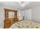 Cozy bedroom with a ceiling fan, neutral walls, plush carpeting, and matching wood furniture at 110 Gulley Glen Dr, Garner, NC 27529