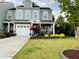 Beautiful two-story home with a manicured lawn and a welcoming front porch adorned with vibrant landscaping at 110 Gulley Glen Dr, Garner, NC 27529
