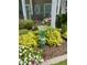 Landscaped front yard featuring a decorative glass bird bath, adding a touch of elegance and charm at 110 Gulley Glen Dr, Garner, NC 27529