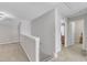 Well-lit hallway featuring neutral paint, carpet, and an open view at 110 Gulley Glen Dr, Garner, NC 27529