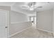 Well-lit hallway featuring neutral paint, carpet, and an open view at 110 Gulley Glen Dr, Garner, NC 27529