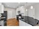Bright kitchen features white cabinets, stainless steel appliances and black countertops at 110 Gulley Glen Dr, Garner, NC 27529