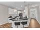 Modern kitchen featuring sleek black countertops, stainless steel appliances, and a stylish breakfast bar at 110 Gulley Glen Dr, Garner, NC 27529