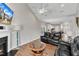 Open concept living room with fireplace, vaulted ceiling, fan, and kitchen access at 110 Gulley Glen Dr, Garner, NC 27529