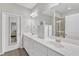 Spacious main bathroom featuring double sink vanity with marble countertop, walk in shower, and white cabinets at 110 Gulley Glen Dr, Garner, NC 27529