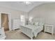 Bright main bedroom featuring a vaulted ceiling, plush carpet, and crisp white furniture at 110 Gulley Glen Dr, Garner, NC 27529