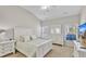 Bright main bedroom featuring a vaulted ceiling, plush carpet, and crisp white furniture at 110 Gulley Glen Dr, Garner, NC 27529