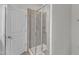 New shower featuring light gray tile surround, glass enclosure, and a modern shower head at 110 Gulley Glen Dr, Garner, NC 27529