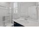 Modern bathroom with a glass-enclosed shower, vanity, and sleek fixtures and countertop at 111 Hickory Plains Rd, Knightdale, NC 27545