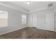 Bedroom with hardwood floors, neutral walls, large window, and closet at 111 Hickory Plains Rd, Knightdale, NC 27545