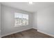 Bedroom with hardwood floors, neutral walls, and large window at 111 Hickory Plains Rd, Knightdale, NC 27545