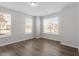 Bright bedroom with natural light, wood-look flooring, and a neutral color palette at 111 Hickory Plains Rd, Knightdale, NC 27545