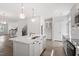 Bright, white kitchen boasts a large island, stainless appliances, and hardwood floors at 111 Hickory Plains Rd, Knightdale, NC 27545