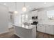 Bright kitchen with white cabinets, quartz countertops, and island with bar seating at 111 Hickory Plains Rd, Knightdale, NC 27545