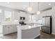 Modern kitchen featuring an island, stainless steel appliances, and white cabinetry at 111 Hickory Plains Rd, Knightdale, NC 27545