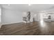 Open concept living area flowing into kitchen with wood floors and a staircase at 111 Hickory Plains Rd, Knightdale, NC 27545